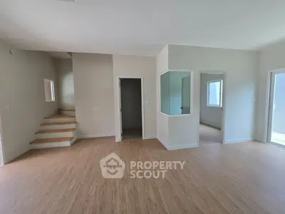 Spacious modern interior with wooden flooring and natural light