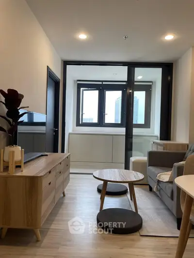 Modern living room with stylish furniture and large windows in a contemporary apartment.