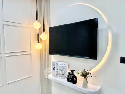 Modern living room with stylish wall-mounted TV and elegant lighting