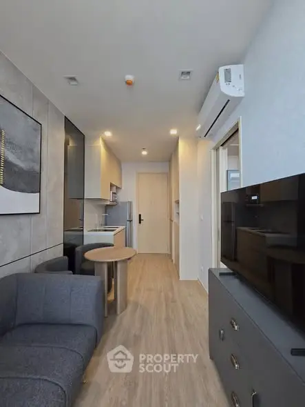 Modern living room with sleek furniture and open kitchen layout