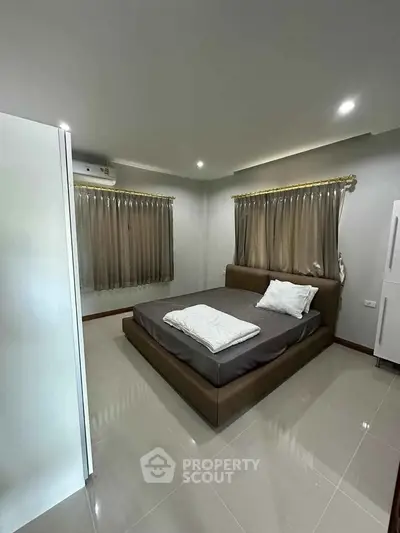 Spacious bedroom with modern design and natural lighting