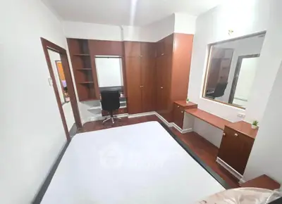 Spacious bedroom with built-in wardrobe and study desk