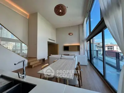 Luxurious modern living room with high ceilings and expansive balcony view