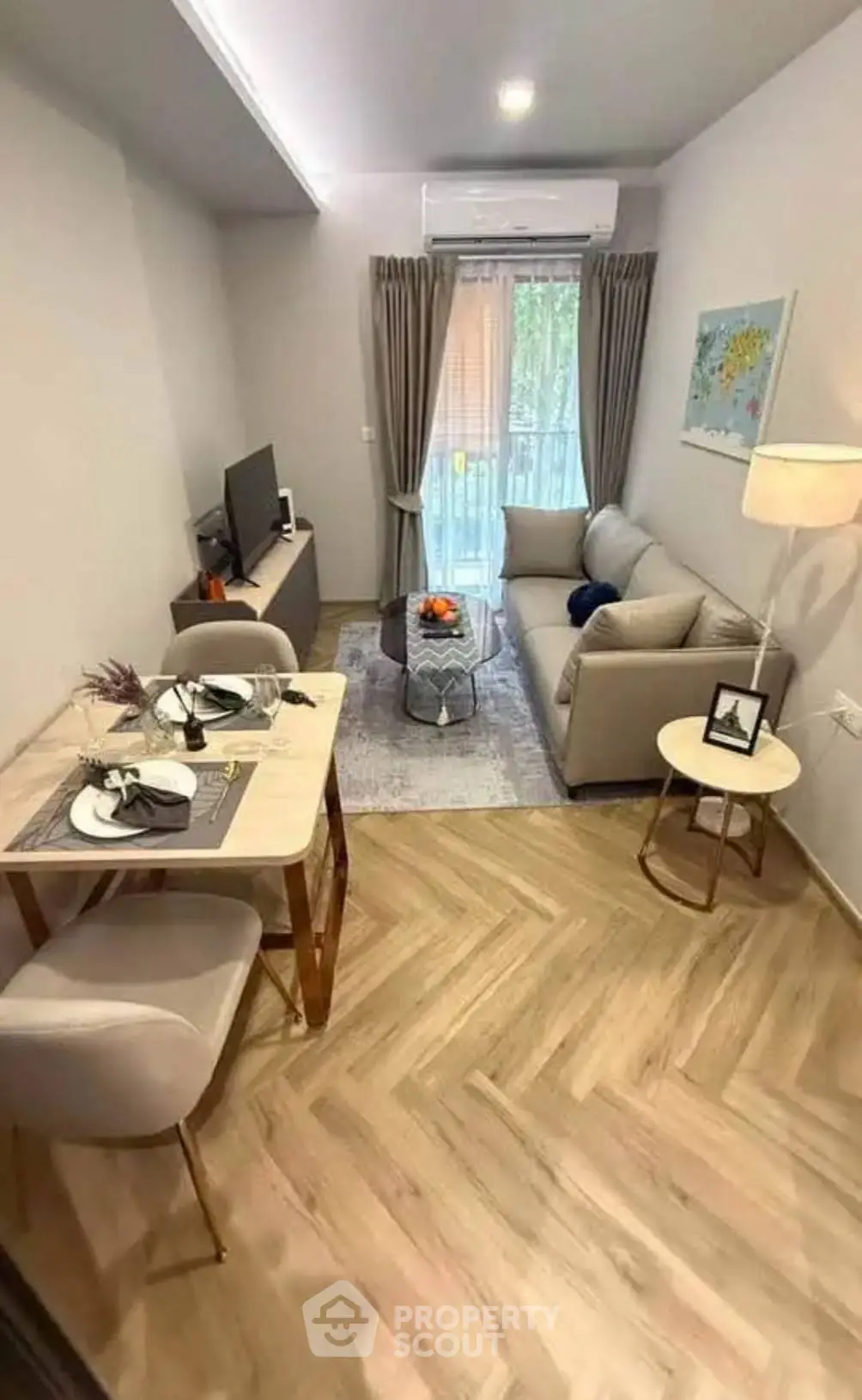 Cozy living room with modern decor and balcony view in a stylish apartment.