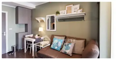 Cozy living room with modern decor, featuring a comfortable sofa, stylish shelving, and a compact dining area.