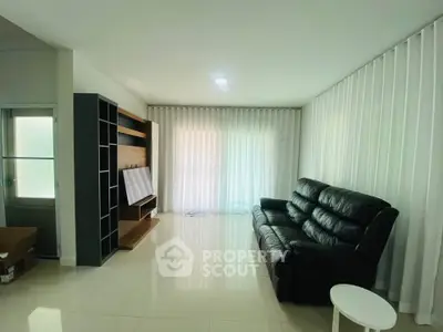 Spacious living room with modern leather sofa and elegant shelving unit