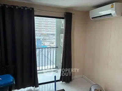 Cozy room with balcony access and air conditioning in urban apartment