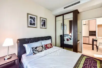 Elegant bedroom with mirrored wardrobe and stylish decor in modern apartment