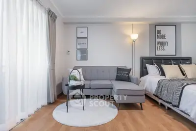 Modern living room with stylish decor and cozy seating area in a bright apartment.