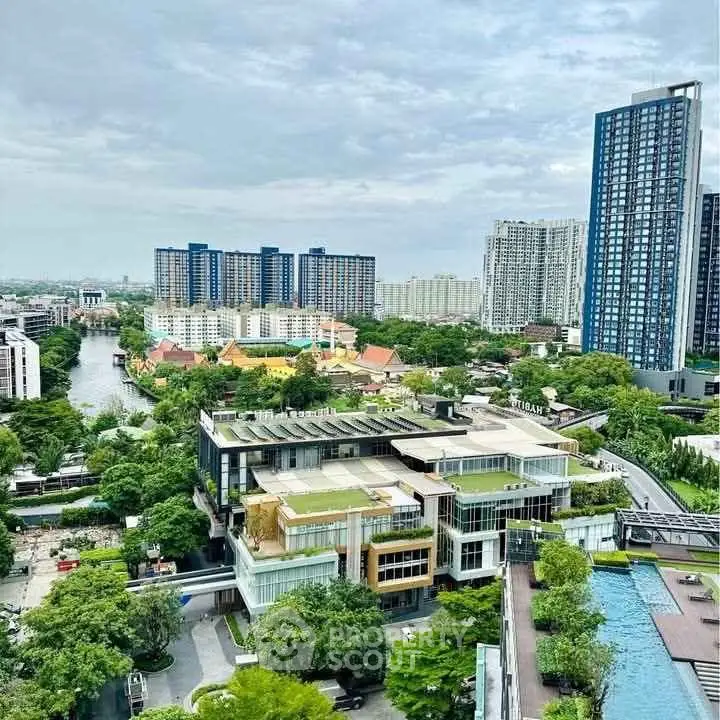 Stunning aerial view of modern urban landscape with high-rise buildings and lush greenery.