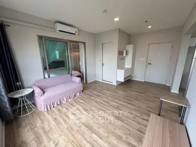 Spacious living room with wooden flooring and cozy furniture in modern apartment