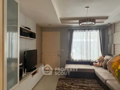 Cozy living room with modern decor, plush sofa, and entertainment center, perfect for relaxation and entertainment.