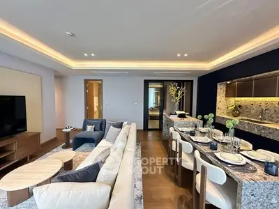 Luxurious open-plan living and dining area with modern decor and ambient lighting.