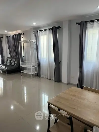 Spacious living room with modern furniture and large windows for natural light.