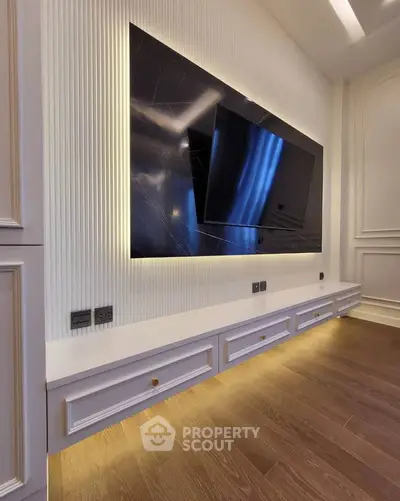 Luxurious modern living room with sleek TV setup and elegant lighting