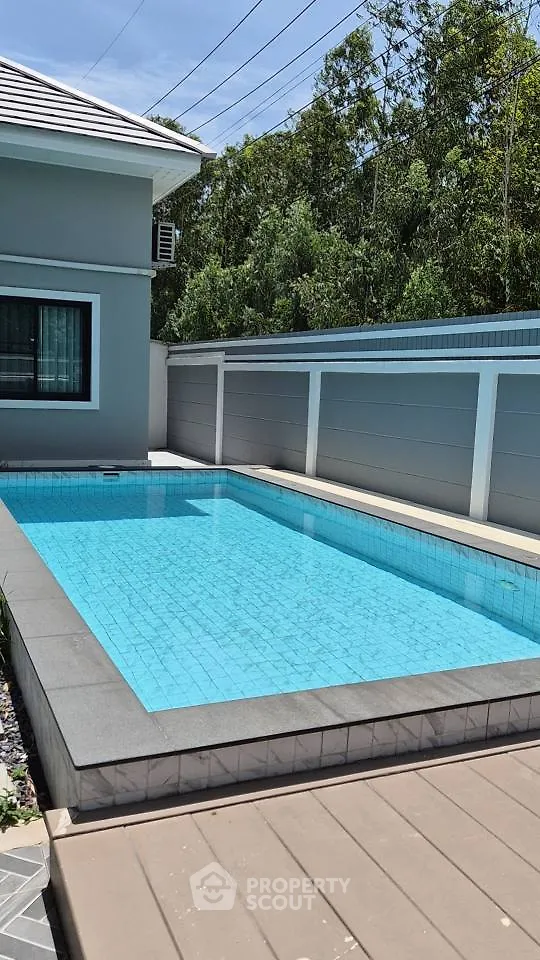 Luxurious private pool in modern residential backyard with sleek design and serene surroundings.