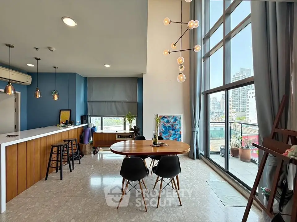 Stunning modern living room with high ceilings and city view, featuring elegant lighting and stylish decor.