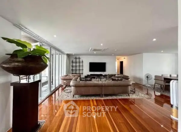 Spacious living room with polished wooden floors and modern decor