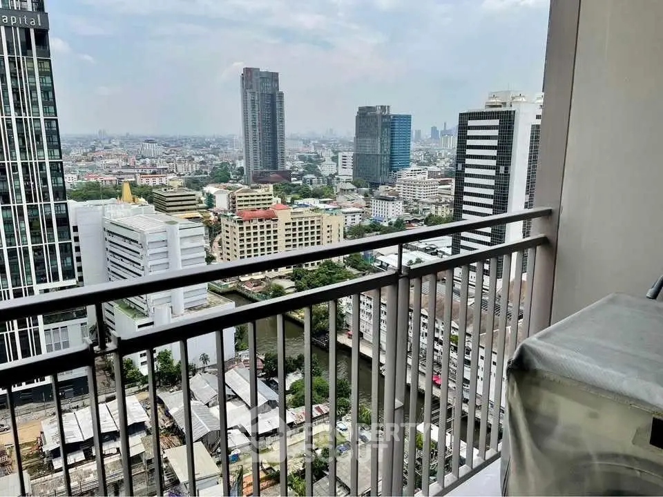Stunning cityscape view from high-rise balcony overlooking urban skyline.