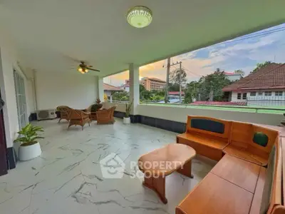 Spacious balcony with elegant seating and scenic view at sunset