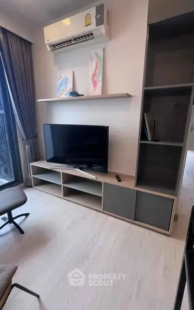 Modern living room with sleek TV unit and air conditioning