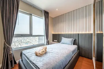 Modern bedroom with city view, featuring sleek design and elegant decor, perfect for urban living.