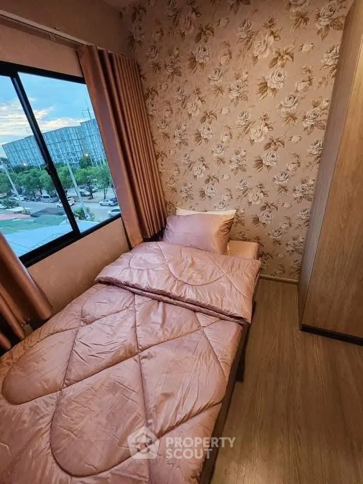 Cozy bedroom with floral wallpaper and city view, perfect for relaxation and comfort.