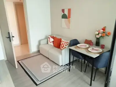 Cozy living room with modern decor and dining area, perfect for small apartments.