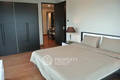 Spacious modern bedroom with sleek wardrobe and elegant decor