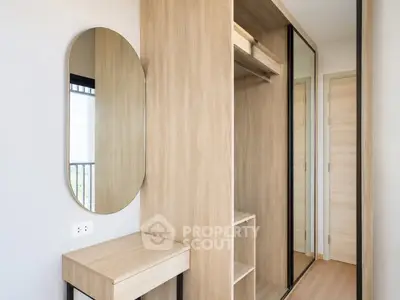 Modern bedroom with stylish wooden wardrobe and oval mirror, featuring sleek design and ample storage space.