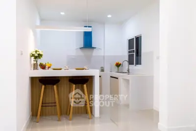 Modern kitchen with sleek design and breakfast bar seating