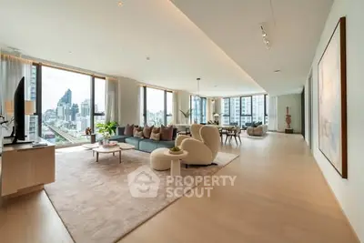 Luxurious open-plan living room with stunning city views and modern decor.