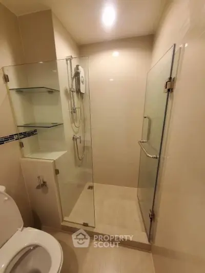 Modern bathroom with glass shower enclosure and sleek fixtures