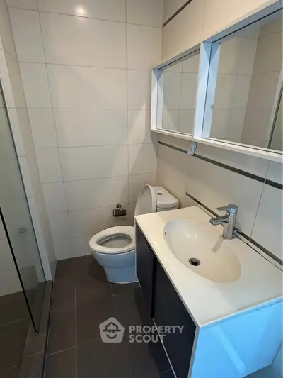 Modern bathroom with sleek fixtures and spacious shower area.