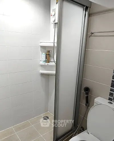 Modern bathroom with shower and toilet in sleek minimalist design
