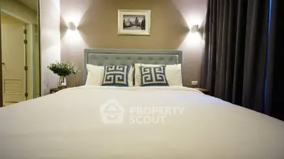 Luxurious bedroom with elegant decor and plush bedding in a modern apartment.