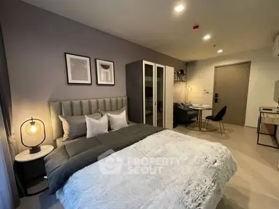 Modern bedroom with stylish decor and cozy ambiance in a contemporary apartment.
