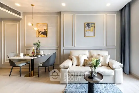 Elegant living room with modern decor and dining area, featuring stylish furniture and wall art.