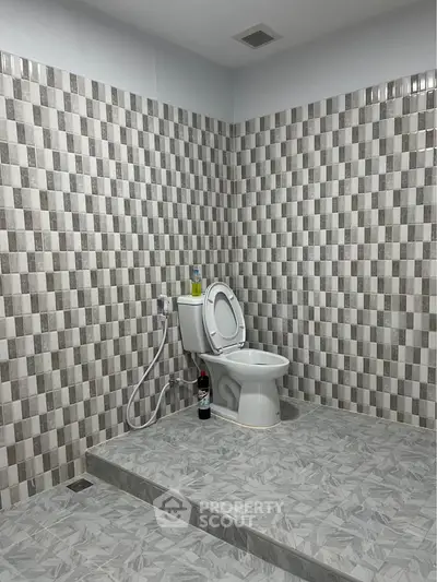 Modern bathroom with checkered tile design and elevated toilet area.