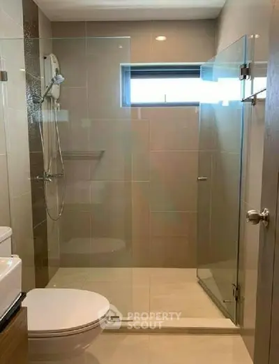 Modern bathroom with glass shower enclosure and sleek fixtures