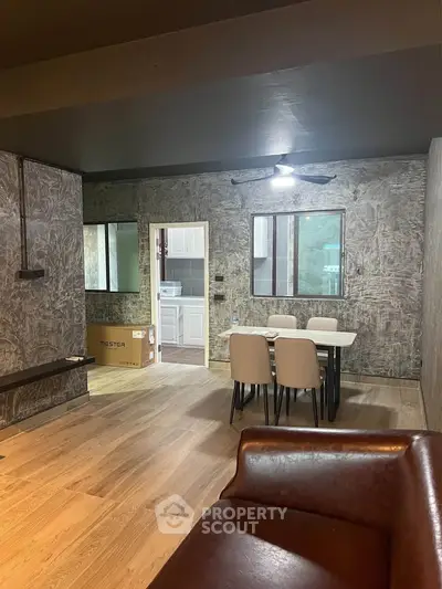 Stylish modern living room with wooden flooring and chic dining area