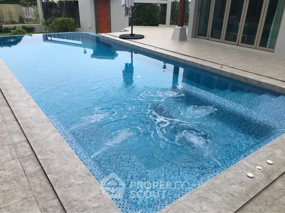 Luxurious outdoor pool with modern design and pristine blue water, perfect for relaxation and entertainment.