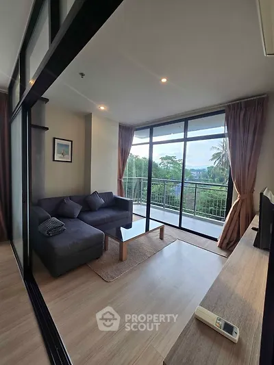 Spacious living room with large windows and balcony offering scenic views, perfect for relaxation.