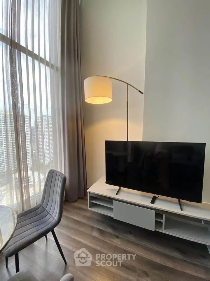 Modern living room with floor-to-ceiling windows and sleek furniture