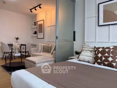 Modern studio apartment with stylish decor, featuring a cozy living area and elegant dining space.