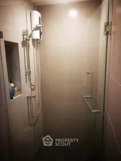 Modern bathroom shower with sleek glass door and built-in shelving