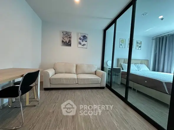 Modern living room with glass partition and cozy bedroom view