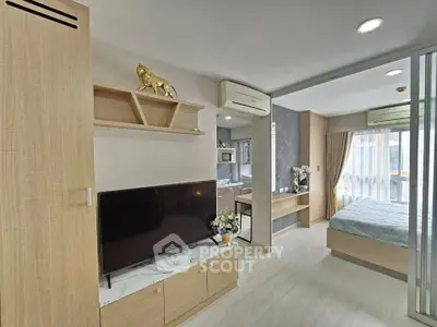 Modern studio apartment with open layout, featuring a cozy living area and stylish bedroom.