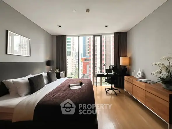 Luxurious bedroom with city view, modern furniture, and elegant decor
