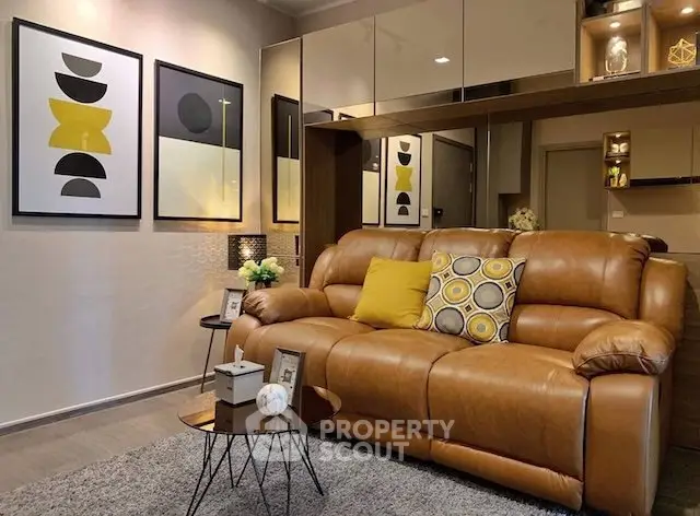 Stylish living room with leather sofa and modern art decor